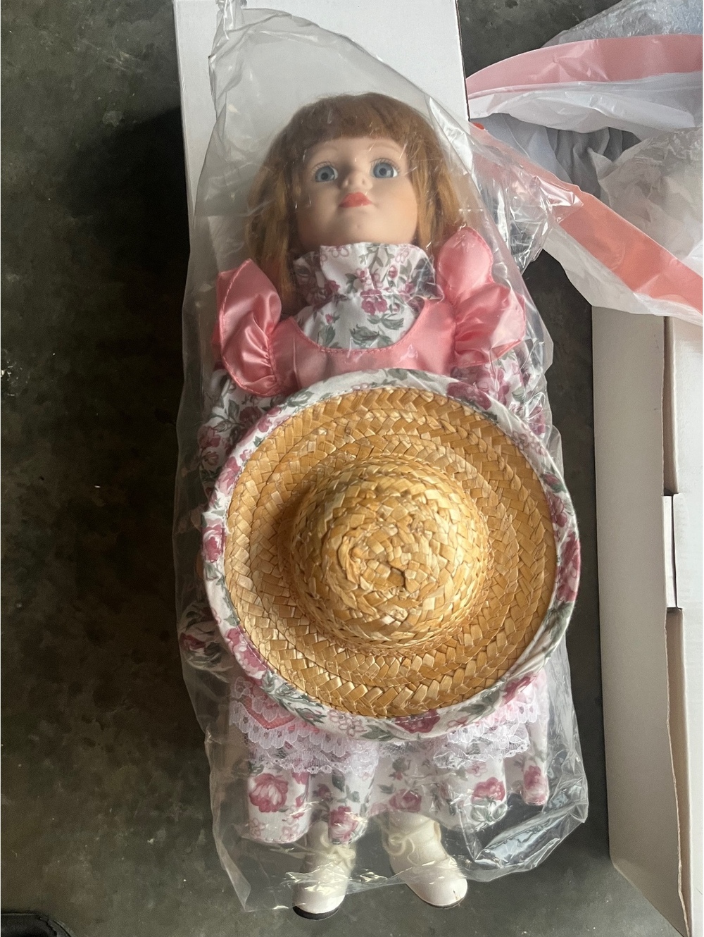 Vintage Porcelain Doll with Floral Dress and Straw Hat